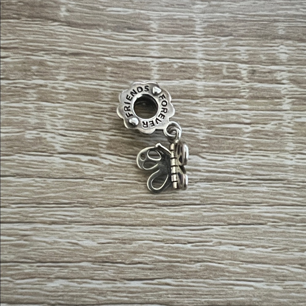 Retired Pandora “Friends Forever” charm. Sterling silver.